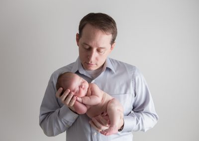 Father with baby girl during newborn session by Colleen Hight in Suwanee, Georgia