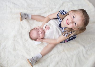 Big sister and baby sister. Newborn portrait session by Colleen Hight.