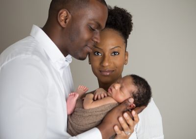 Family photo from a newborn portait session with Mom, Dad, and newborn baby boy