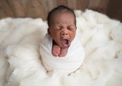 Newborn Baby Boy Yawning during Newborn Portraits in Suwanee, Georgia