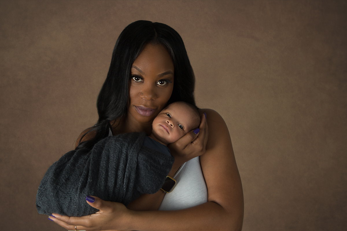 Mother holds her baby son in Alpharetta newborn session