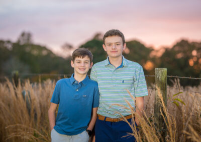 Teen brothers at sunset in field in Lawrenceville, Georgia