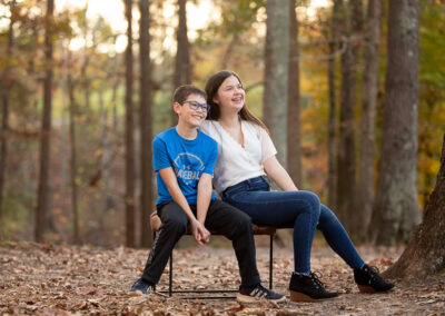Brother and sister laughing together during family photo session in Marietta, Georgia